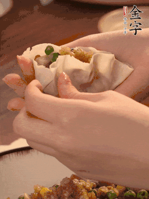 取一大勺馅料放进饺子皮里，用大拇指按住顶部馅料，再用虎口掐出形状。
