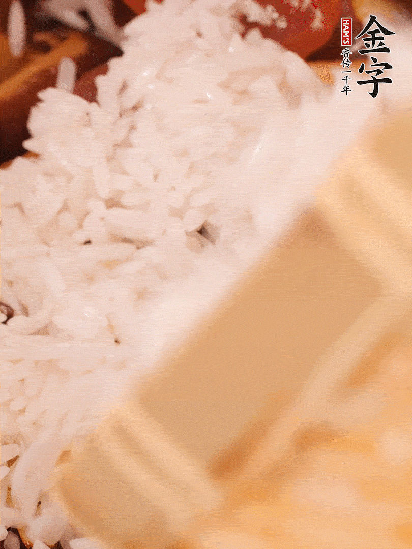 接着倒入提前浸泡的大米，加生抽、食盐、白胡椒粉，一起翻炒均匀。